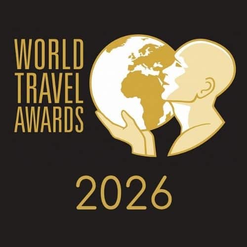 World Travel Awards 2026 logo: a gold globe cradled by a head silhouette on a dark background.